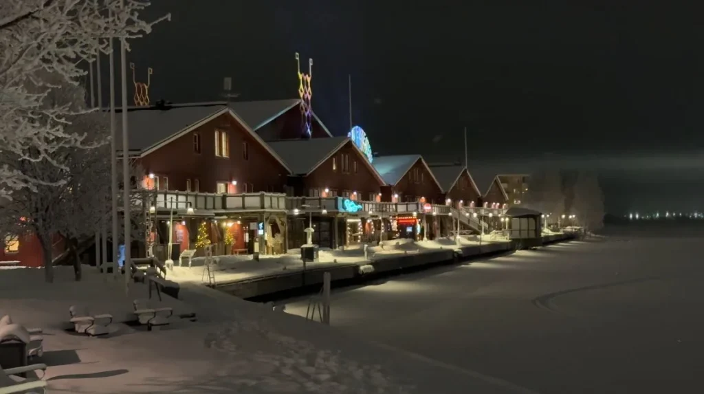 buildings by frozen water at night