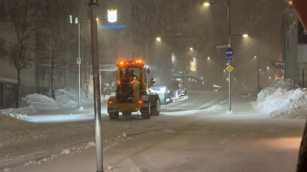 Luleå street at night with plow