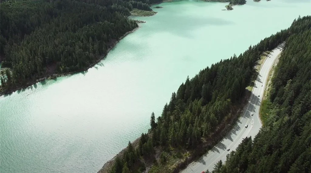 turquoise lake aerial view with road